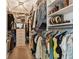 Spacious walk-in closet with custom shelving, hanging rods, and drawers for optimal organization at 11519 Crowned Sparrow Ln, Tampa, FL 33626
