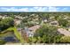Overhead view of a neighborhood showcasing homes with pools, lush landscaping, and scenic ponds at 12910 Vicksburg Dr, Tampa, FL 33625