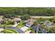 An aerial view captures a residential neighborhood with mature trees, a pond, and well-maintained homes at 12910 Vicksburg Dr, Tampa, FL 33625