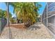Well-maintained backyard with rock landscaping and a glimpse of the screened-in patio at 12910 Vicksburg Dr, Tampa, FL 33625