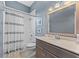 Bathroom with shower/tub combo with white tile and a gray vanity at 12910 Vicksburg Dr, Tampa, FL 33625