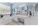 Bathroom featuring a double sink vanity with marble countertops, a soaking tub, and tiled floors at 12910 Vicksburg Dr, Tampa, FL 33625