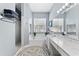Bright bathroom with marble countertops, a soaking tub, and a separate walk-in shower at 12910 Vicksburg Dr, Tampa, FL 33625