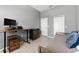 Bedroom with desk, cabinets, tile flooring, and a closet for ample storage at 12910 Vicksburg Dr, Tampa, FL 33625