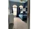 Blue bedroom with bunkbeds, carpet flooring, dresser and windows at 12910 Vicksburg Dr, Tampa, FL 33625