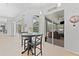 Bright dining area with sliding doors leading to a screened patio and pool, perfect for indoor-outdoor living and relaxation at 12910 Vicksburg Dr, Tampa, FL 33625