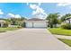 Charming one-story home featuring a well-manicured lawn, wide driveway, and an attached two-car garage at 12910 Vicksburg Dr, Tampa, FL 33625