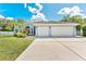 Inviting single-Gathering home boasts a 3-car garage, a well-kept lawn, and beautiful curb appeal at 12910 Vicksburg Dr, Tampa, FL 33625