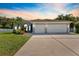 Beautiful home with a well-manicured lawn, large driveway, and a spacious three-car garage, great for families at 12910 Vicksburg Dr, Tampa, FL 33625