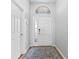 Bright entryway with a stylish front door and a patterned rug, welcoming guests into a well-lit interior space at 12910 Vicksburg Dr, Tampa, FL 33625