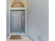 Inviting front entrance with a decorative door and a 'welcome' mat, creating a warm and friendly first impression at 12910 Vicksburg Dr, Tampa, FL 33625
