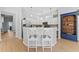 Modern kitchen featuring white cabinetry, stainless steel appliances, and a breakfast bar with seating, perfect for casual dining at 12910 Vicksburg Dr, Tampa, FL 33625