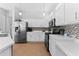 Well-lit kitchen featuring stainless steel appliances, light wood floors, and mosaic tile backsplash at 12910 Vicksburg Dr, Tampa, FL 33625