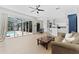 Spacious open-concept living area with seamless flow between the living room, dining space, kitchen, and outdoor pool area at 12910 Vicksburg Dr, Tampa, FL 33625