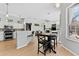 Open-concept living space featuring a modern kitchen, dining area, and comfortable living room, ideal for entertaining at 12910 Vicksburg Dr, Tampa, FL 33625