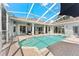 Inviting in-ground pool and covered patio with lounge seating, perfect for outdoor entertaining and relaxation at 12910 Vicksburg Dr, Tampa, FL 33625