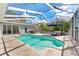A sparkling in-ground pool with a screened enclosure, perfect for outdoor relaxation and enjoyment at 12910 Vicksburg Dr, Tampa, FL 33625