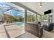 Inviting covered patio with a pool, lounge seating, and outdoor dining area, great for entertaining at 12910 Vicksburg Dr, Tampa, FL 33625