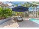 A covered poolside lounge area offers an inviting space to relax and unwind amidst lush landscaping at 12910 Vicksburg Dr, Tampa, FL 33625