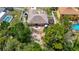 Aerial view of a home featuring a large backyard, patio set, trampoline, and surrounded by a white fence at 13337 Tubeck St, Spring Hill, FL 34609