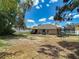 The home's backyard features a deck with seating, swing set, trampoline, and scattered pine straw at 13337 Tubeck St, Spring Hill, FL 34609