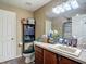 Bathroom with wooden cabinet vanity, a mirror, and a tiled countertop at 13337 Tubeck St, Spring Hill, FL 34609