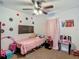 A charming bedroom features a ceiling fan, carpeted floor, closet, and painted accent wall at 13337 Tubeck St, Spring Hill, FL 34609