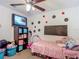 A charming bedroom features a ceiling fan, carpeted floor, and entertainment center at 13337 Tubeck St, Spring Hill, FL 34609