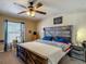 Bedroom with wooden bed frame, ceiling fan, and a cat tree near the window at 13337 Tubeck St, Spring Hill, FL 34609
