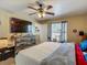 Bedroom featuring dresser with mounted tv, ceiling fan, and a cat tree near the window at 13337 Tubeck St, Spring Hill, FL 34609