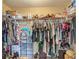 Walk-in closet with ample storage, rods and shelves for clothes and shoes at 13337 Tubeck St, Spring Hill, FL 34609