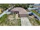An eye-level view of a single-story home with a two car garage, driveway, and fenced yard at 13337 Tubeck St, Spring Hill, FL 34609