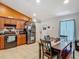Open kitchen area with stainless steel refrigerator, tile floors, and a view of dining area at 13337 Tubeck St, Spring Hill, FL 34609