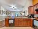 Kitchen area with dark wood cabinets and black appliances, connected to the living space at 13337 Tubeck St, Spring Hill, FL 34609