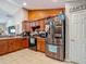 Well-lit kitchen features stainless steel appliances and plentiful wood cabinets at 13337 Tubeck St, Spring Hill, FL 34609