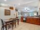 Open kitchen layout with dark cabinetry, dining area, and views of the spacious living room at 13337 Tubeck St, Spring Hill, FL 34609
