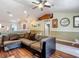 Spacious living room with open layout featuring hardwood floors and cozy sectional sofa at 13337 Tubeck St, Spring Hill, FL 34609