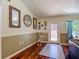 Open living room features hardwood floors, mirrors on the wall, and exterior access at 13337 Tubeck St, Spring Hill, FL 34609