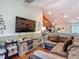 Open living area boasts hardwood floors, and comfortable seating, plus a view to the kitchen at 13337 Tubeck St, Spring Hill, FL 34609