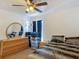 This main bedroom features a ceiling fan, dresser with mirror, and a carpeted floor at 13337 Tubeck St, Spring Hill, FL 34609