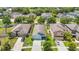 An aerial view of a suburban home with landscaped yard, a driveway, and partial street view at 13806 Reindeer Cir, Hudson, FL 34669
