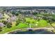 Panoramic aerial view of the neighborhood with homes, a pool, a park, and a lake at 13806 Reindeer Cir, Hudson, FL 34669