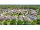 An aerial view of the neighborhood showing many homes and landscaping in a green lush area at 13806 Reindeer Cir, Hudson, FL 34669