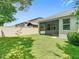 A beautiful fenced backyard with a screened in patio area with plenty of green grass for activities at 13806 Reindeer Cir, Hudson, FL 34669