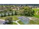 Community basketball court surrounded by trees, grass and neighborhood homes at 13806 Reindeer Cir, Hudson, FL 34669