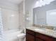 Well-lit bathroom with a granite countertop, a bathtub, and shower at 13806 Reindeer Cir, Hudson, FL 34669