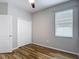 Bedroom with wood-look floors, a closet, and a window at 13806 Reindeer Cir, Hudson, FL 34669