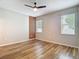 This bedroom features wood flooring, bright lighting, and large window at 13806 Reindeer Cir, Hudson, FL 34669