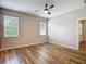 This bedroom features new flooring, bright lighting, and two windows at 13806 Reindeer Cir, Hudson, FL 34669