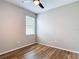 Bedroom with wood-look floors, a ceiling fan, and a window at 13806 Reindeer Cir, Hudson, FL 34669